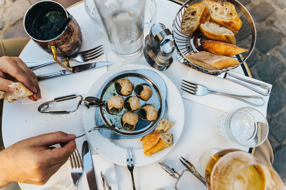 Restaurante caça-turista em Paris: 7 sinais para fugir 2 Mesa com prato de culinária francesa, pão e bebida